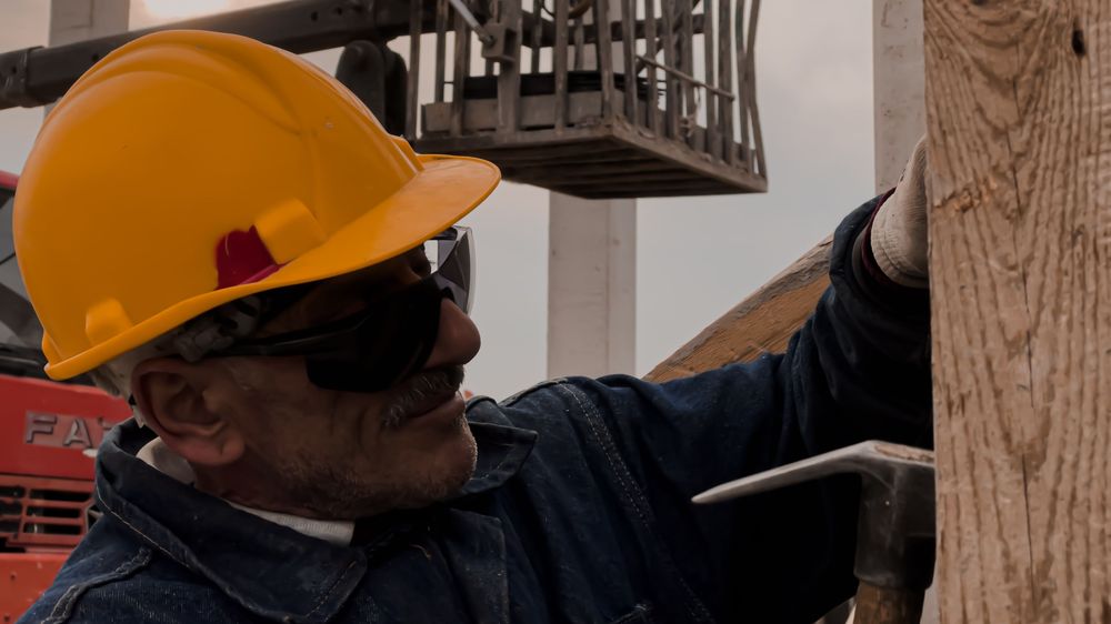 Contractor inspecting a job site wearing a hard hat